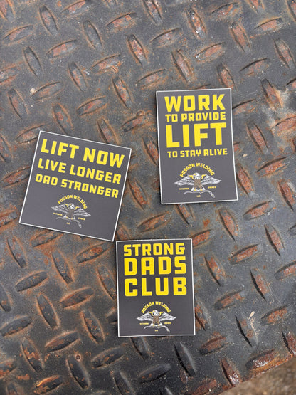 Three motivational stickers on a textured metal surface