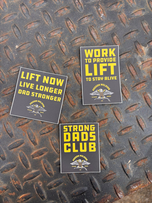 Three motivational stickers on a textured metal surface